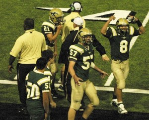 Redmond quarterback Michael Conforto (No. 8) pumps up the home crowd after scoring the first touchdown of the game last Friday against Eastlake. Led by Conforto's 119 rushing yards