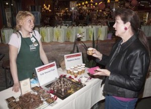 Whole Food employee Summer Kolberg (left) educates Rebecca Houser on the finer points of raspberry mochas