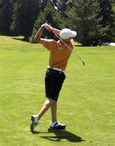 Redmond High School senior Charlie Mroz swings away at the Bear Creek Country Club range on Wednesday. Mroz