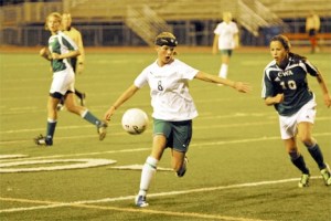 The Overlake School freshman midfielder Quinn Phillips gets ready to kick the ball upfield as Charles Wright freshman Katie Meyer (No. 10) looks on during the Owls’ tri-district tournament opener on Wednesday at Sammamish High School. The Owls won