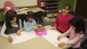 Nozomi Japanese Christian School students decorate button pins that will be handed out on Sunday as part of the school's 'Pray for Kids in Japan' fundraiser. Money from the fundraiser will go to a preschool in Japan that was affected by the earthquake and tsunami last month. From left