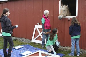 A Little Bit Therapeutic Riding Center horse keeps an eye on volunteers on Comcast Cares Day.