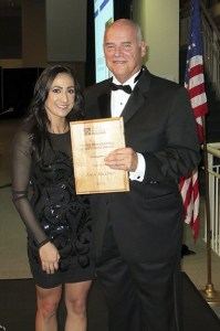 Jenn Mueller of John L. Scott Real Estate and Northwest Dream Team in Redmond receives her Young Professionals Achievement Award from Larry Christensen