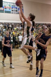 Senior guard Jamie Meyer flies to the hoop for two of his game-high 27 points last Saturday in the Grizzlies' 57-53 win over the 3A Eastside Catholic Crusaders at the Bear Creek School.