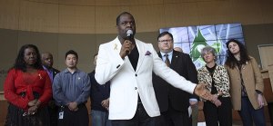 Shane Coakley (center) addresses the crowd at Redmond City Hall during a demonstration against racism. Behind