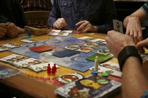Calliope Games personnel play a prototype of a game for the Titan Series at an International Tabletop Day event in Bellevue.