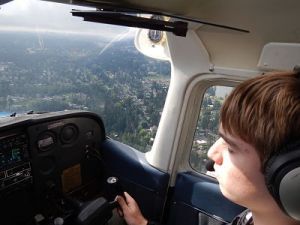 A Redmond Boy Scout takes the controls while in flight with an Experimental Aircraft Association (EAA) pilot.