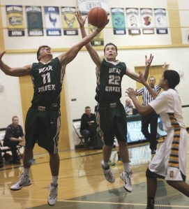 Bear Creek's AJ Rial (left) and Micah Tardy reach for the ball at the end of the first half during last night's game against Overlake.