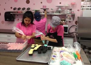 PinkaBella employees prepare cupcakes.