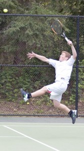 Overlake School junior Marcus Munoz goes airborne for a slam during the Owls’ 4-1 win over Bear Creek on Tuesday afternoon at The Overlake School. Munoz and his doubles partner Trevor Partington beat Alex Finkleson and Reed Joslyn 6-3