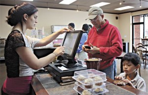 Yih Chuang and his son Jaden purchase baked goods from the Flying Apron Bakery in downtown Redmond. Jaden has a number of food allergies and the new organic