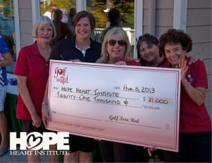 Golf Fore Red participants present a check to the Hope Heart Institute.