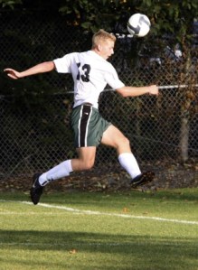 Bear Creek forward Ryan Strandin leaps up to head the ball during the Grizzlies’ 3-0 win against King’s West at The Bear Creek School on Tuesday. Ryan Strandin scored his league-leading 15th goal of the season against the Warriors.