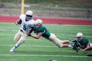 Redmond High’s Gerald Wright attempts to evade a tackler during last Friday’s Green versus Gold scrimmage. Redmond will host Newport at 7 p.m. tonight in the league opener.