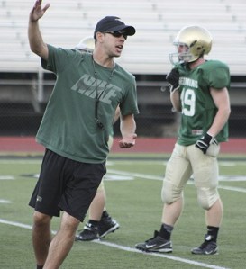 Redmond High head football coach Jason Rimkus leads his team through a practice in 2014.