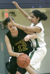 Forest Ridge’s Tanya Shah (No. 14) applies some defensive pressure to Overlake’s Jessica Elliott during second-quarter action of the Owls’ 46-24 win last Friday night. Elliott scored a season-high 19 points and grabbed 13 rebounds as Overlake won its fourth straight game.