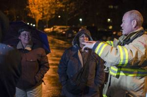 Redmond firefighter Rob Torrey speaks with Sue Anderson