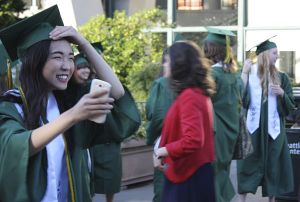 A Redmond High School senior rushes toward her friends last night prior to the Mustang commencement ceremony at KeyArena in Seattle. Archana Mandava was the student speaker and senior class president Suzi French also addressed the Class of 2013 at the event.