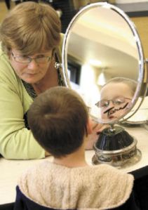 Optical Manager Diane Charles works with Joshua Kellar