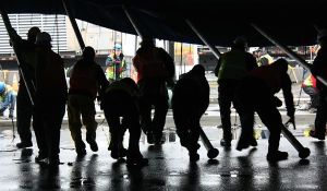 Workers raise the blue-and-yellow Big Top this afternoon for Cirque du Soleil's production of 'Kurios