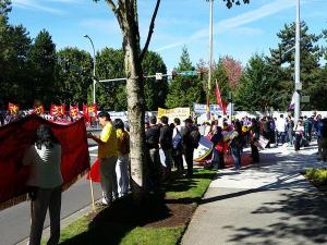 People line up along Northeast 40th Street near the Microsoft campus in Redmond this afternoon awaiting Chinese President Xi's arrival.