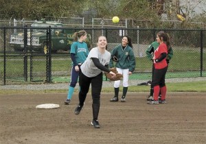 Louise Chouinard throws across the diamond during a recent softball practice at Redmond High