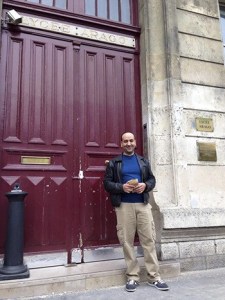Khalid Kaskou stands in front of his high school