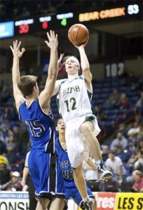 Bear Creek School senior Jamie Meyer goes up for a layin while Soap Lake senior Kyler Moats defends during the Grizzlies' consolation quarterfinal matchup against the Eagles. The Grizzlies won