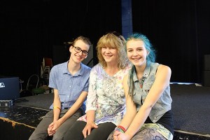 Redmond High School junior Erich Schleck (left) and sophomore Ember Johnston are organizing a benefit concert to help Sherrill Taylor (center) after she and her husband lost everything in a fire that burned down their Kirkland condo.