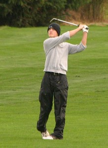 Redmond High senior Oliver Rudnicki fires his approach to the par-5 18th hole at Eagle's Talon (Willows Run Golf Club) during the 4A Kingco District Tournament on Wednesday. Despite struggling to a second-round 82