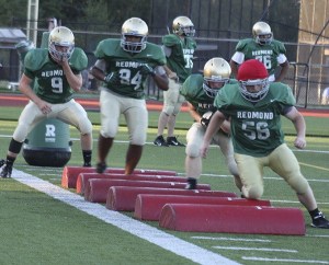 Redmond High Mustangs run through drills at practice.