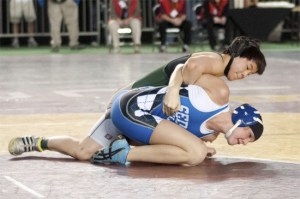 Redmond High senior Catherine Kelly (top) takes down Sedro-Wooley's Andrea Iversen at last year's state tournament - the Mat Classic at the Tacoma Dome. Kelly placed fourth tournament last year and she is looking to better that finish this season.