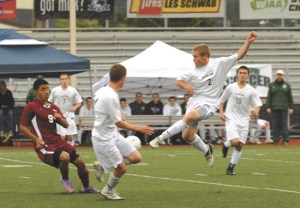 Overlake junior defender Marcus Munoz (No. 2) gets airborne for a kick as his teammates look on during the Owls' championship match against Wahluke last Saturday. Munoz