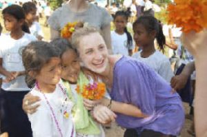 Overlake senior Calla DiPietro poses with Cambodian students during a playground completion party in Pailin