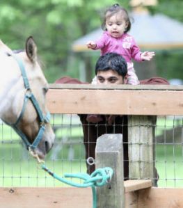 Paul Delgado holds his daughter