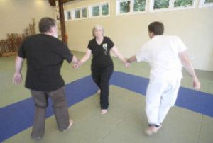 Susan Mix demonstrates an “outward wrist throw” with her husband
