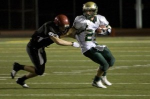 Redmond senior wide receiver Cameron Sandquist eludes an Eastlake defender during the Mustangs’ 55-37 loss to the Wolves Friday night. Sandquist caught 15 passes for 244 yards — both school records.