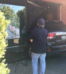 A passerby surveys the scene where a driver crashed her car through the front of Inchin’s Bamboo Garden this morning. Courtesy photo