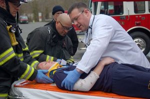Instructors and Medic One paramedics-to-be work on a “patient” at a trauma training session.