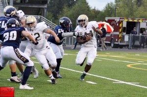 Redmond High’s Cameron Boone runs upfield during last night’s game. Courtesy of Marc LaPierre
