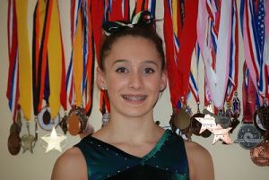 Redmond High’s Sierra Mukerjee is surrounded by some of her championship medals.