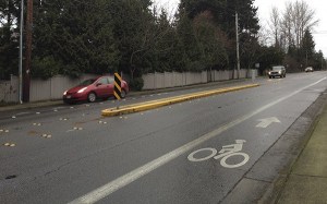 Cars drive by one of the islands located in the center lane along 166th Avenue Northeast. Concerns were recently raised regarding whether emergency vehicles are able to maneuver onto and from side streets when responding to calls.