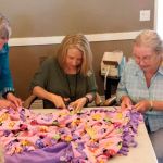 From left, Aegis of Redmond resident Karen Hammond, Tammy Hervey (life enrichment director at Aegis of Redmond) and resident Phyllis Bordner make blankets for children and families in need. Courtesy photo