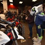 Seattle Seahawks mascot Blitz admires a motorcycle alongside another enthusiast at the Ducati Redmond grand opening last Saturday at Redmond Town Center. Courtesy of Ducati Redmond