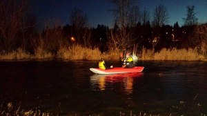A King County Sheriff&rsquo;s Office Marine Rescue Dive Unit member ferries a stranded kayaker to safety on Monday night on the Sammamish River. Courtesy photo