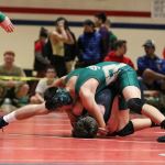 Redmond sophomore Jobe Zuniga gains ground on Lake Washington junior Logan Heenan in the 120-pound championship match on Saturday at Juanita High School in Kirkland. Redmond won the Class 2A/3A KingCo Conference championship. JOHN WILLIAM HOWARD/Kirkland Reporter