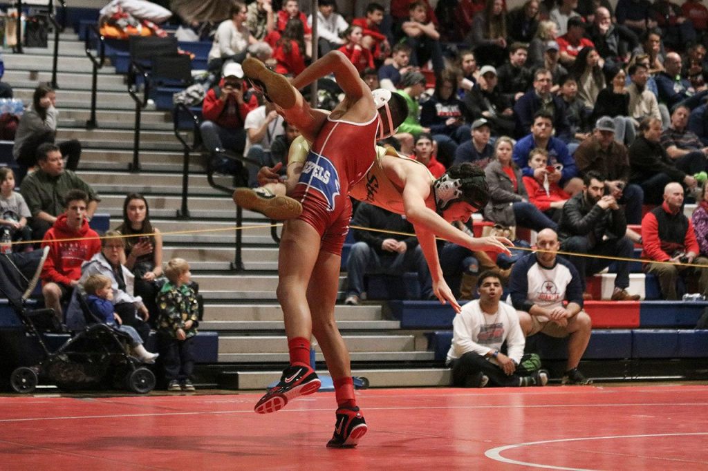 Juanita&rsquo;s King Kotalas throws Redmond&rsquo;s Nadav Levanoni in the finals of the 113-pound weight bracket at the Class 2A/3A KingCo Conference championships on Saturday at Juanita High School in Kirkland. JOHN WILLIAM HOWARD/Kirkland Reporter
