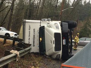 Semi truck rolls over in Redmond