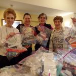 From left, Fairwinds Redmond resident Cynthia Zerbe, activity director Randee Young and residents Penny Niemela and Char Vasilatos with Needs Kits they assembled with hygiene items to be distributed to homeless students of the Lake Washington School District. Courtesy photo
