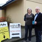 SoulFood Coffehouse co-owner Makia Oaks (left) and FlyBuy CEO Wil Merritt at the FlyBuy pick-up point behind the coffee shop. Samantha Pak, Redmond Reporter